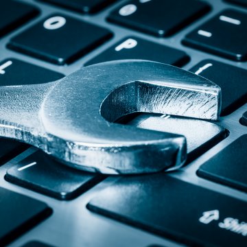 reimage repair utility software windows mac wrench on computer keyboard 